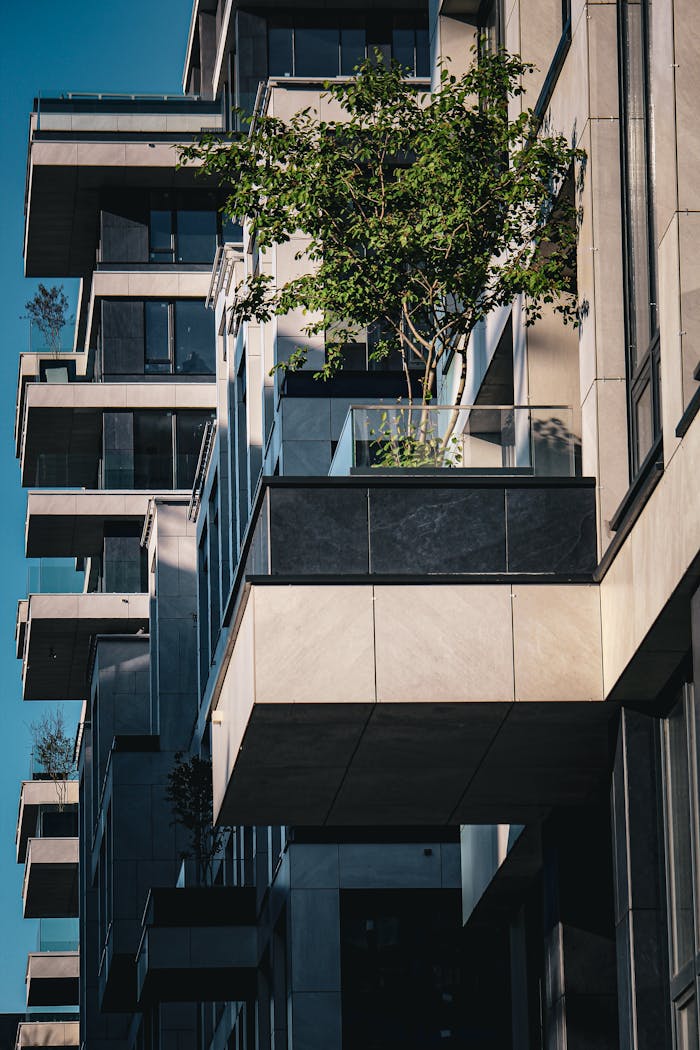 hero-img-02 A striking view of modern balconies adorned with greenery in an urban setting.